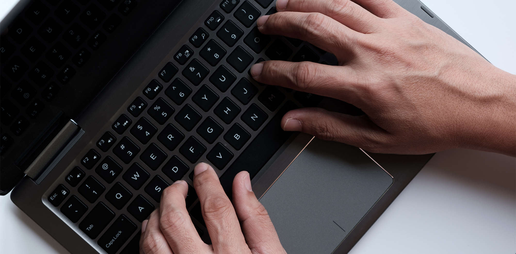 Hands typing on computer