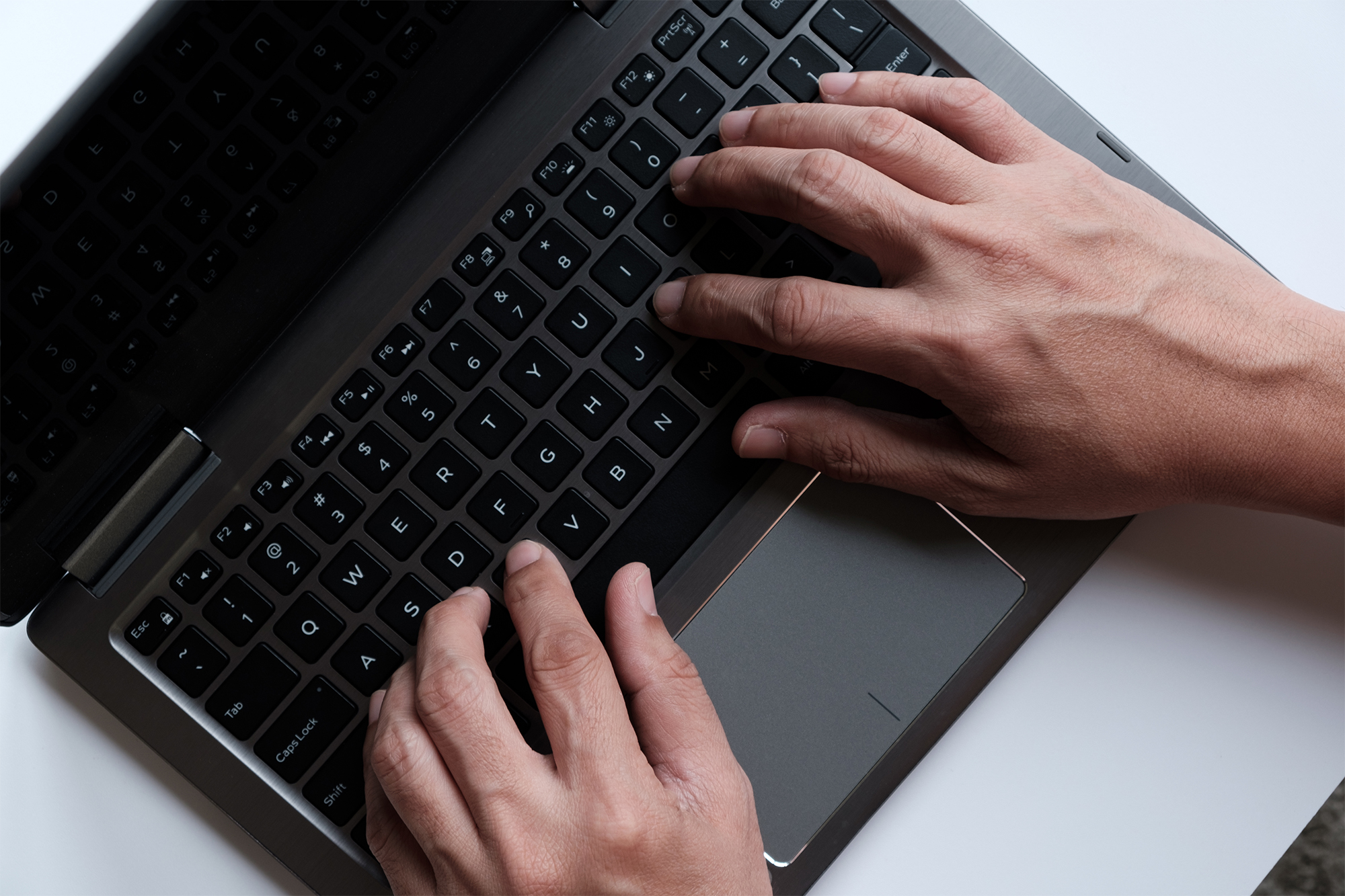 Hands typing on computer