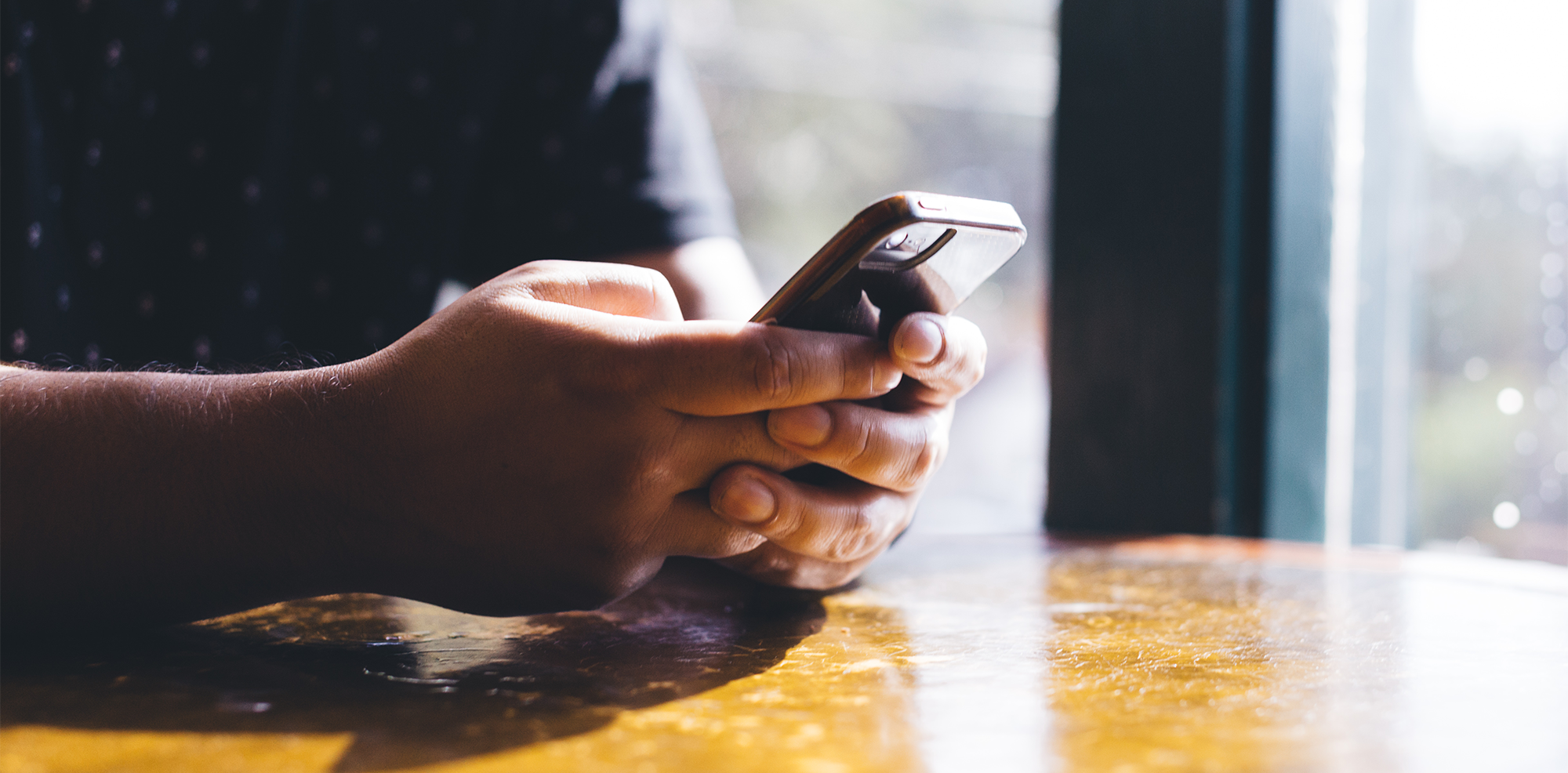 Man holding cell phone and texting